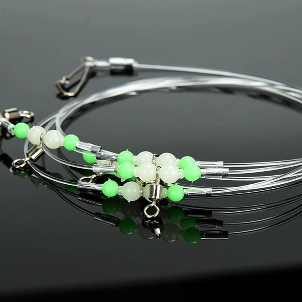 Fishing leader rig set with green and white beads and multiple metal swivel hooks