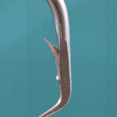 Close-up of stainless steel circle hook needle point and curved wire