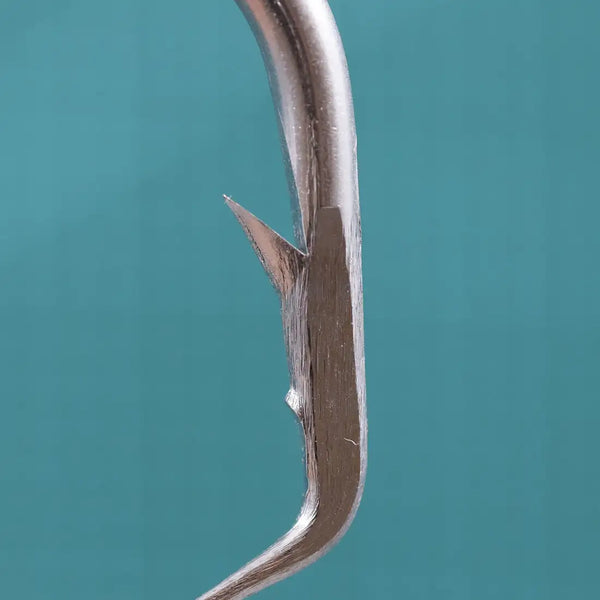Close-up of stainless steel circle hook needle point and curved wire