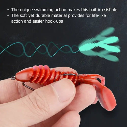 Red translucent silicone jigging lure worm held in hand with metal hook loop