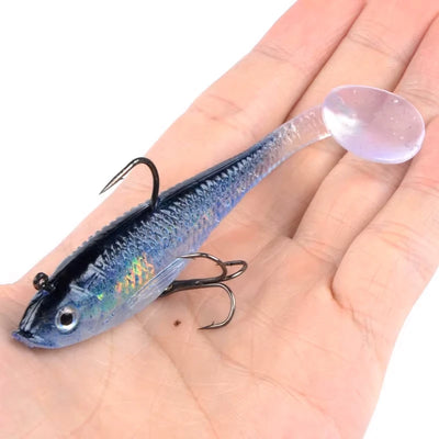 Luminous dark blue fishing lure with treble hooks, held on an open palm