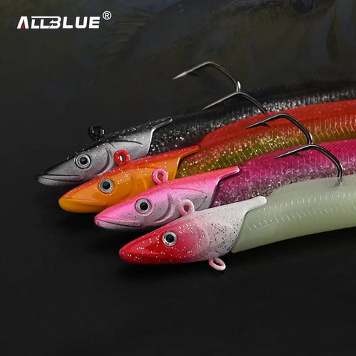 Soft paddle tail fishing lures set with treble hooks in red, pink, orange, and green.