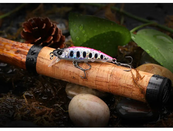 Sinking minnow fishing lure with pink-and-white speckled pattern and treble hooks