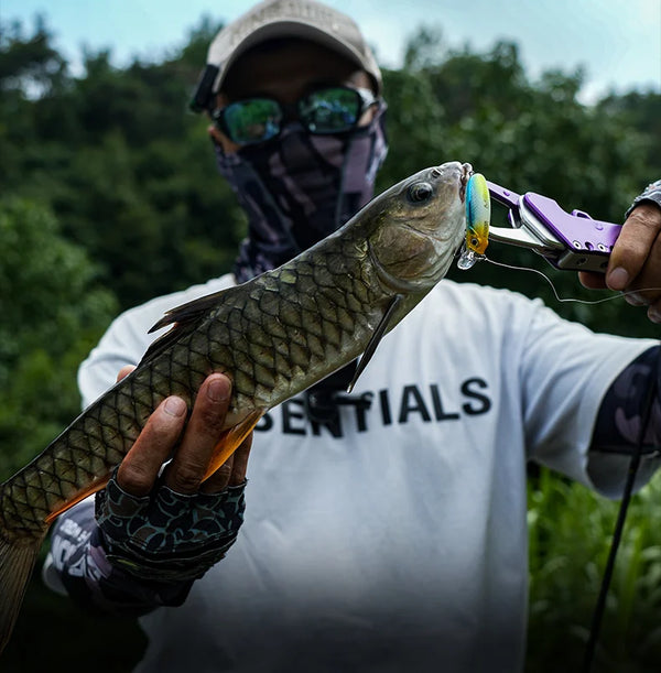 Freshwater fish held with a micro minnow lure near the mouth