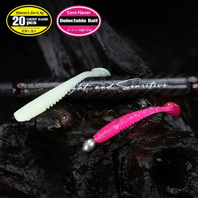 Soft plastic worm lures: white body with faint specks and pink glitter tail