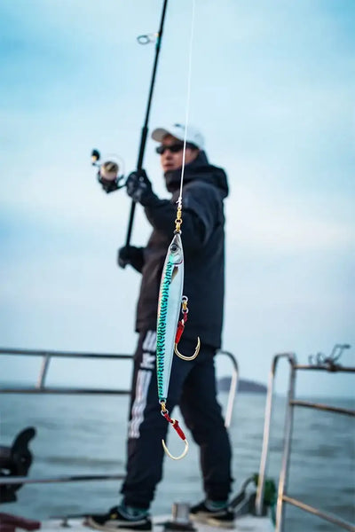 Floating pencil sea fishing lure, turquoise-blue body with red treble hook