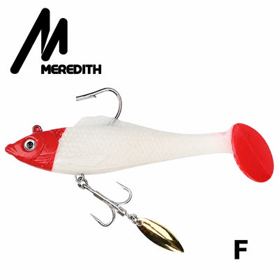 Red-and-white soft plastic swimbait lure with gold spinner blade and metal hooks