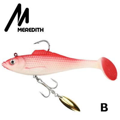 Red-and-white soft plastic swimbait lure with gold spinner blade and treble hooks