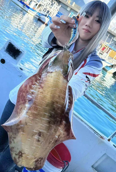 Large squid with yellow-brown pattern attached to a red-and-blue squid jig lure