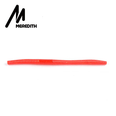 Red silicone worm fishing lure with faint specks and ribbed texture