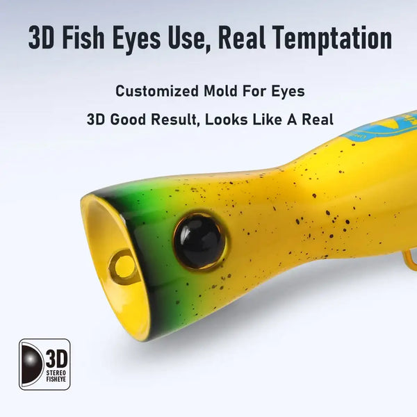 Yellow floating popper lure with green underside, round black eye, gold front cup