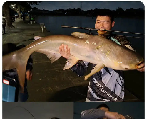 Angler holding a spinning rod while landing a large fish at night