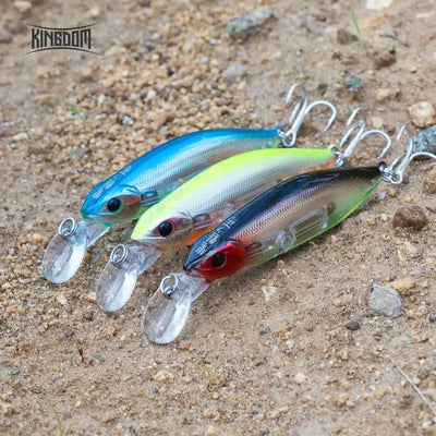 Three slow-sinking minnow lures with clear lips and treble hooks in blue, lime, and brown