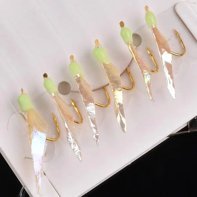 Set of fishing rigs with green head beads, gold hooks, and translucent fish-skin bodies.