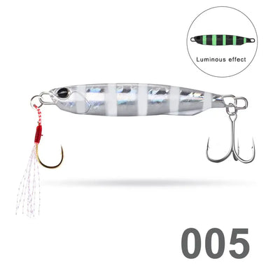 Silver striped fishing pencil jig lure with luminous green center, twin treble hooks, red tassel