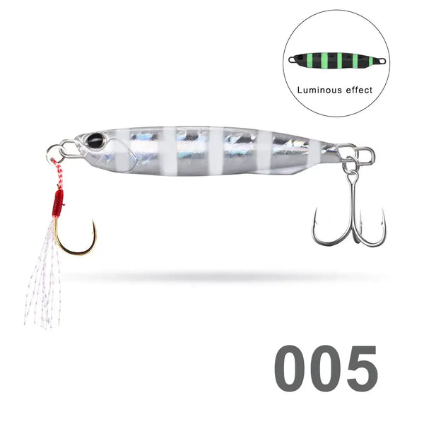 Silver striped fishing pencil jig lure with luminous green center, twin treble hooks, red tassel
