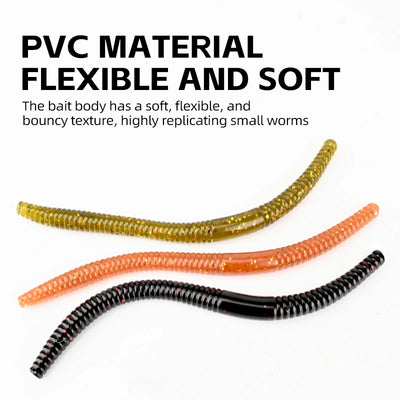 Curved silicone worm baits in gold, orange, and black with speckled texture