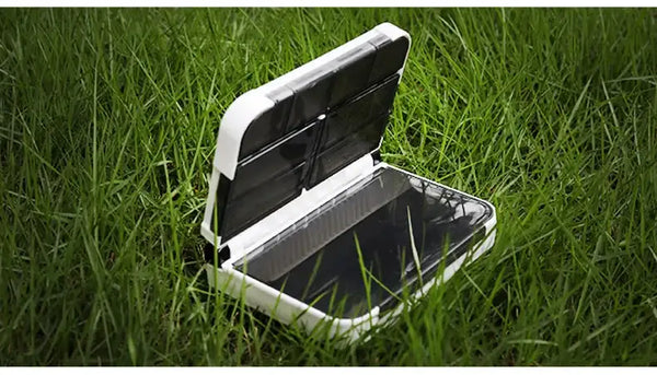 KINGDOM mini fishing tackle box storage case, white open with clear divider tray, outdoors on grass