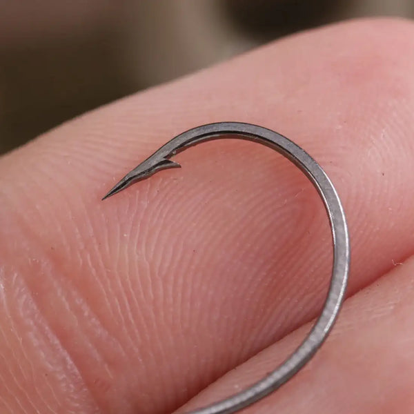 Single drop shot fishing hook in close-up, curved shank and sharp point