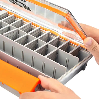 Interior divided tray inside orange fishing tackle box, hand sliding compartment