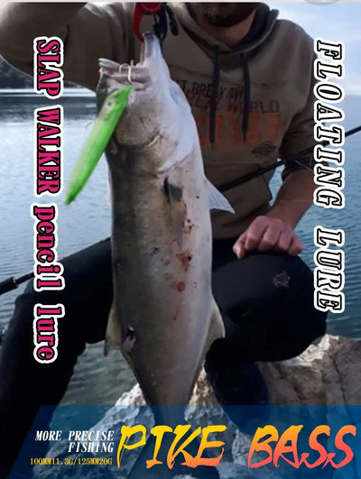 Bass fishing photo featuring a green lure and a caught fish on a rocky shore