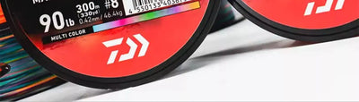 Orange and multicolor braided PE fishing line on reel, J-BRAID EXPEDITION X8