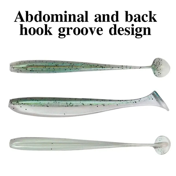 Soft plastic shad lures in grey-green and clear with rounded T-tail ends.