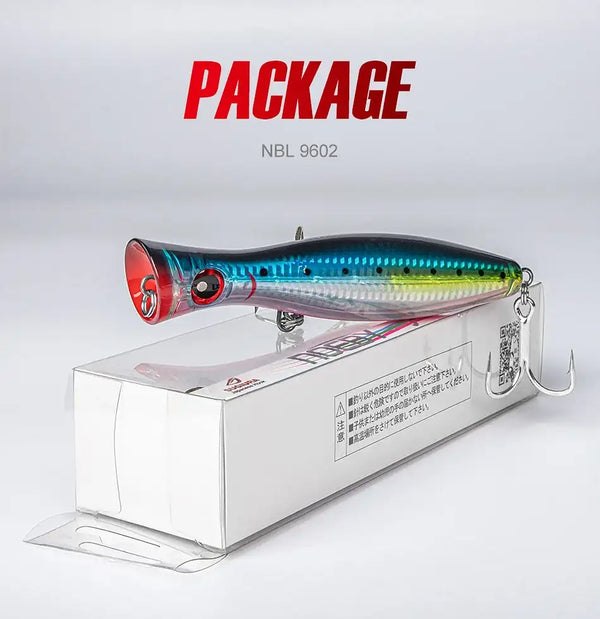 Blue-green topwater popper hard bait with red face and treble hooks, in box