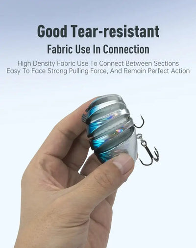 Blue-silver segmented hard bait fishing lure held in a hand