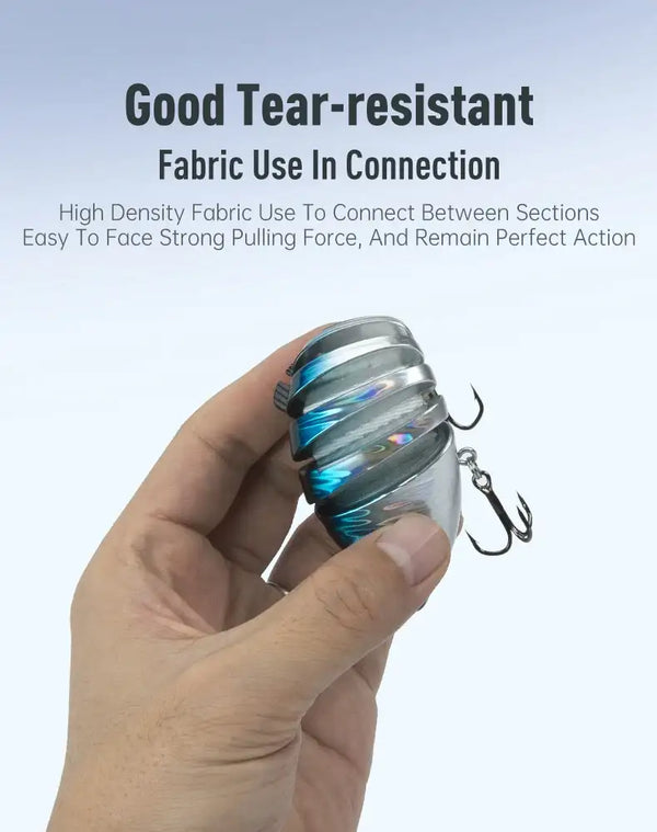 Blue-silver segmented hard bait fishing lure held in a hand