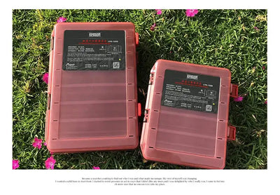 Two red and dark double-sided tackle boxes with hinged lids and snap locks