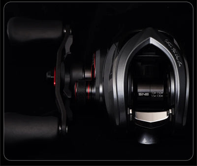 Baitcasting fishing reel side view with metal frame and red adjustment accents