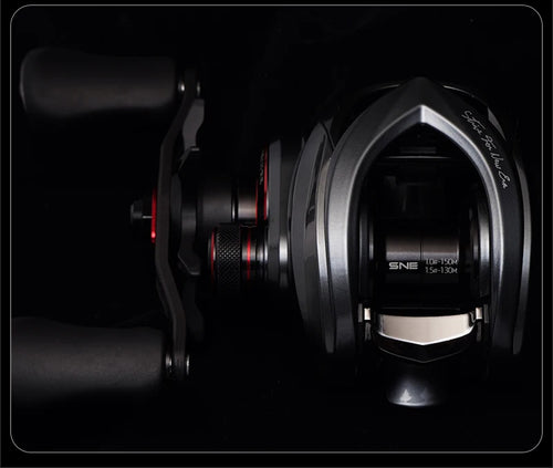 Baitcasting fishing reel side view with metal frame and red adjustment accents