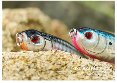 Blue-white topwater pencil lure with pink side accents, rotating tail and treble hooks