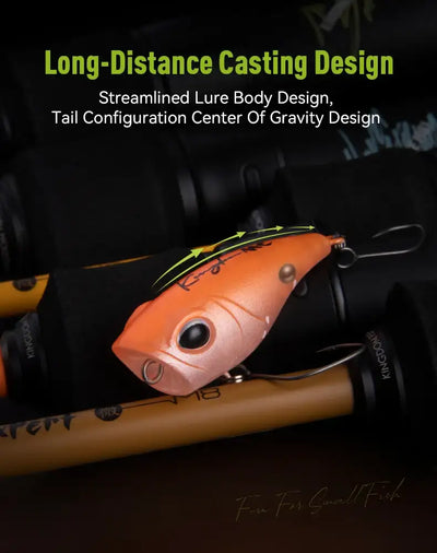 Orange floating micro popper lure near a fishing rod, with front single hook