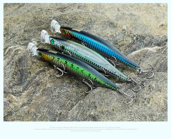 Floating minnow lures on rocks, teal-blue and green bodies with clear lips and treble hooks