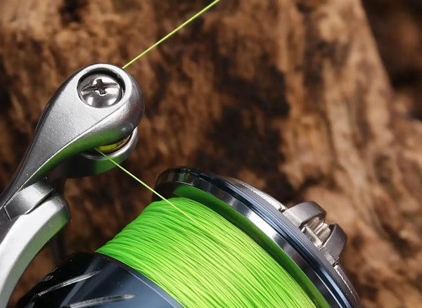 Close-up of neon green braided line on a spinning reel spool