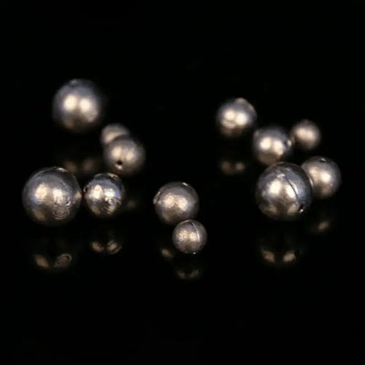 Cluster of dark gray round hollow lead ball sinkers, pendant style with holes