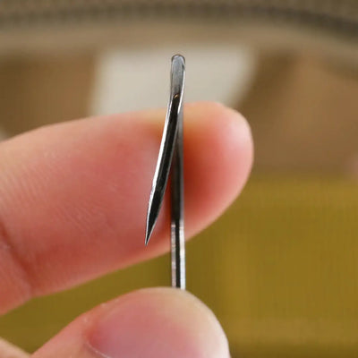 Single needle-point fishing hook, close-up on pointed tip and shank