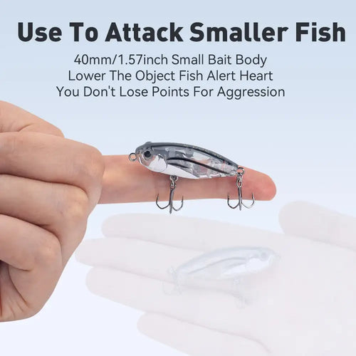 Floating pencil stickbait lure held in hand, silver-blue body with treble hooks