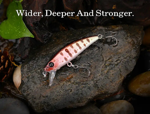 TSURINOYA Intruder 51S sinking minnow lure on rocks, speckled pink-and-white body, treble hooks