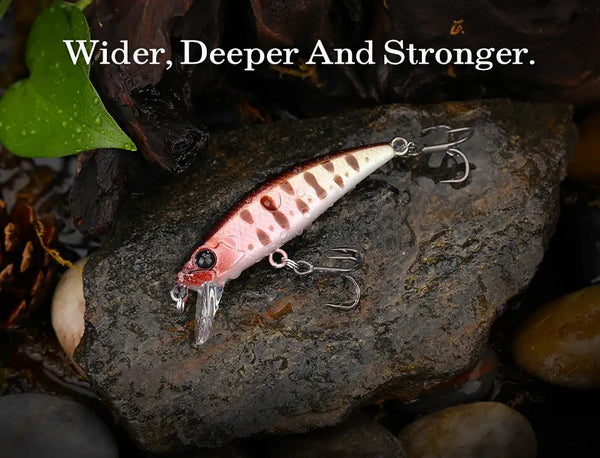 TSURINOYA Intruder 51S sinking minnow lure on rocks, speckled pink-and-white body, treble hooks