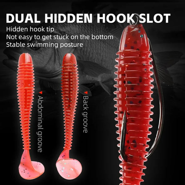 Red soft fishing lures with paddle tail, showing hidden hook slot detail.