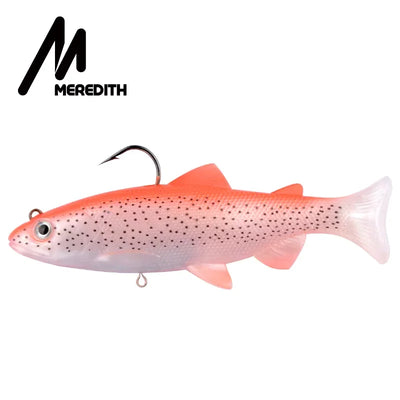 Weighted soft swimbait lure, orange-pink with speckles, 3D eyes, T-tail, treble hook