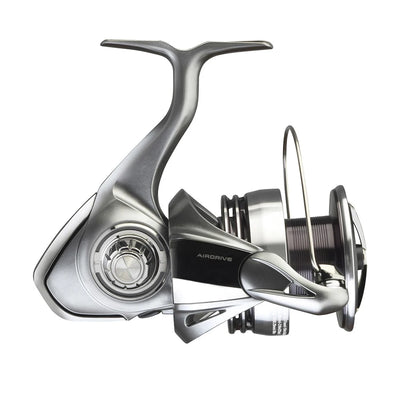 Silver spinning fishing reel with side drag knob and bent handle, angled view