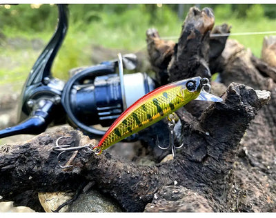 Sinking minnow fishing lure with green-yellow body and multi-color stripe, on treble hooks
