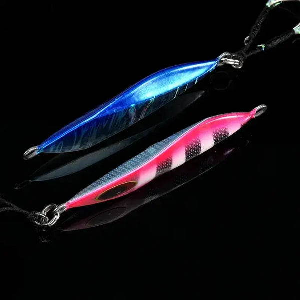 Blue and pink metal fishing jigs with red eye, split-ring hooks and trailing skirt