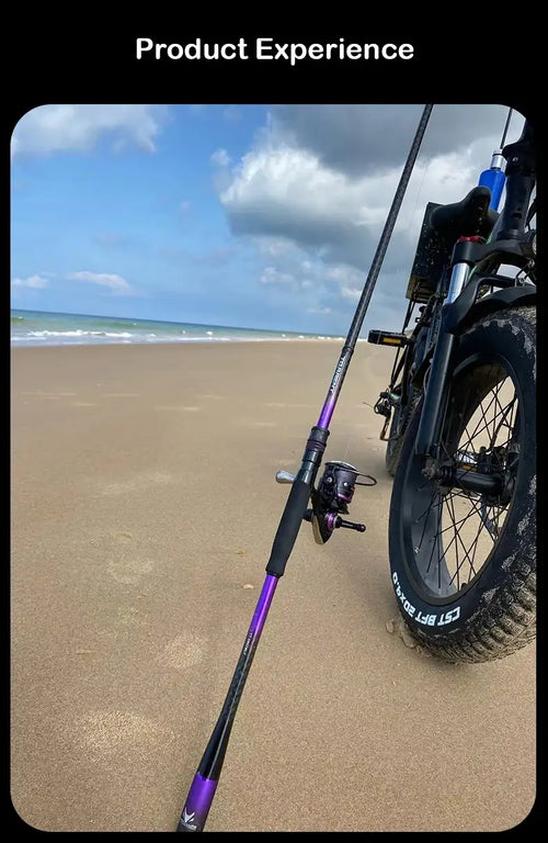 Casting fishing rod with purple shaft and reel, held on sandy beach
