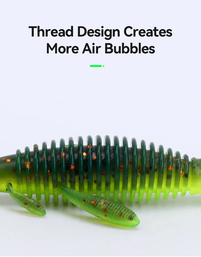 Soft shrimp fishing lure in dark green with neon orange dots, worm-style body