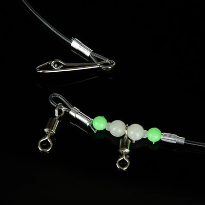 Fishing leader rig with green and white beads, snaps, and metal swivel connectors